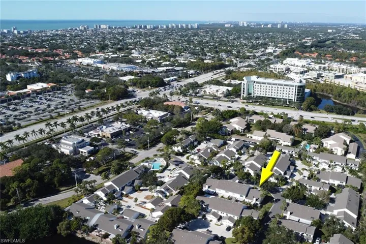 Aerial view of property and surrounding area with nearby urban area and a nearby body of water