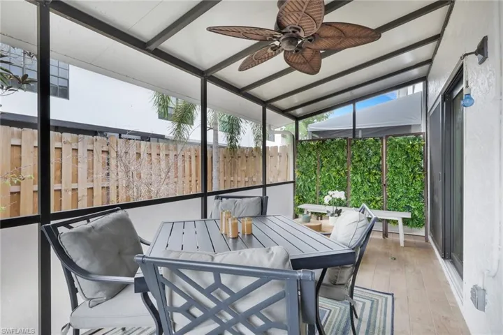 Screened Lanai with outdoor dining area, a ceiling fan, and a patio