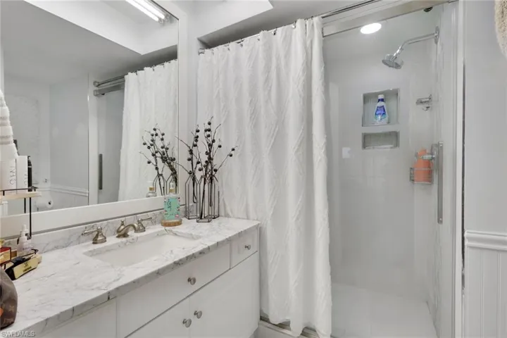 Bathroom featuring a shower stall and vanity