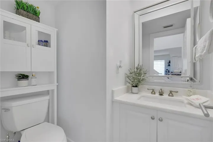 Powder room featuring vanity and toilet