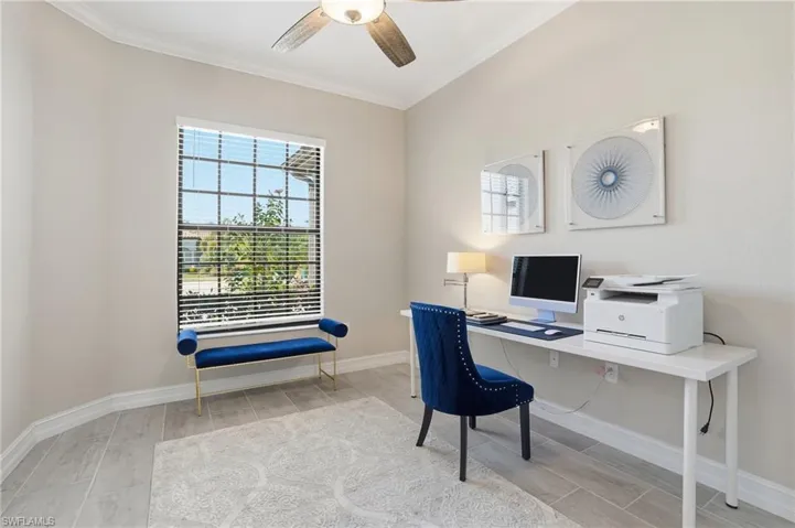 Office space featuring wood tiled floors, ornamental molding, and a ceiling fan