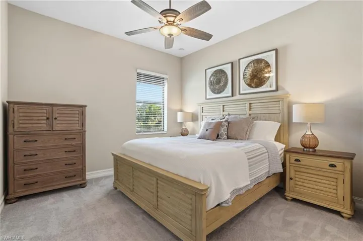 Bedroom featuring light carpet and a ceiling fan