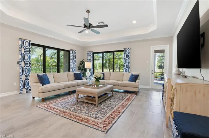 Living room with a ceiling fan and crown molding