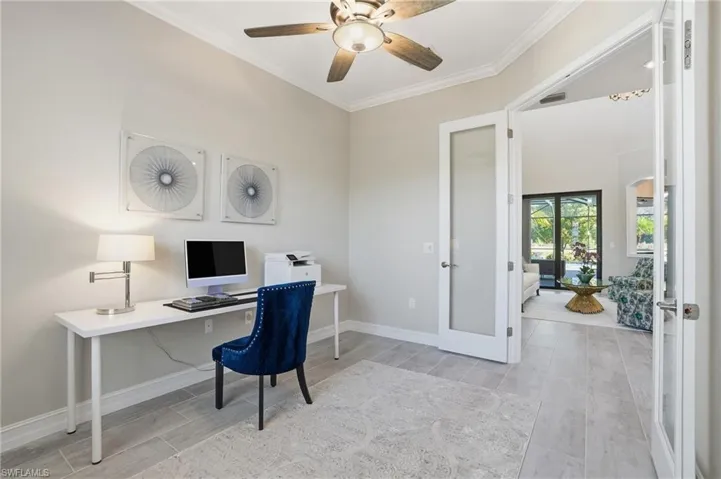 Office area featuring french doors, wood finish floors, ornamental molding, and ceiling fan