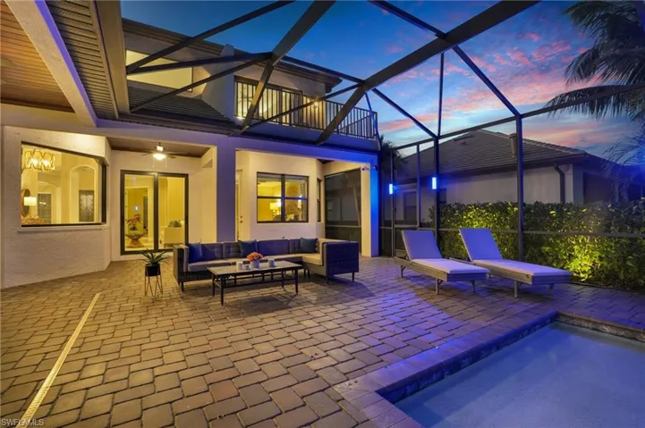 Patio terrace at dusk with a sunroom, a lanai, an outdoor hangout area, and a patio area