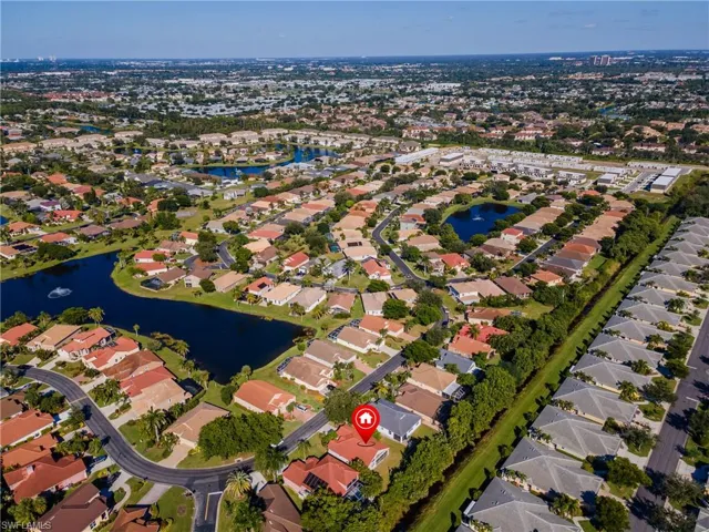 Aerial overview of property's location featuring a large body of water and nearby suburban area