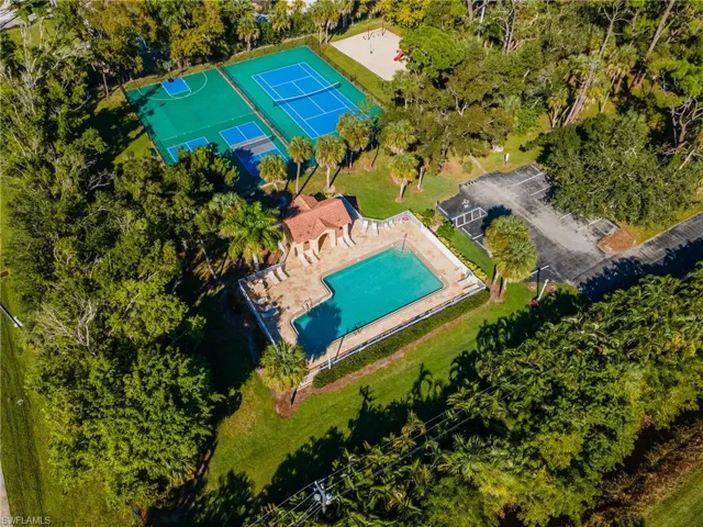 Aerial view of a pool and a tree filled landscape
