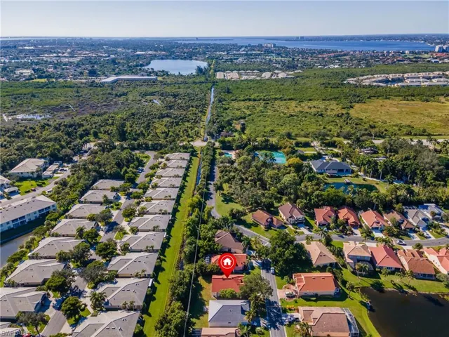 Aerial view of property and surrounding area with nearby suburban area