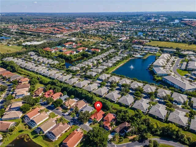 View of property location featuring a nearby body of water and nearby suburban area