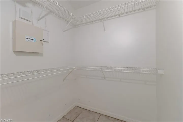 Walk in closet with light tile patterned flooring