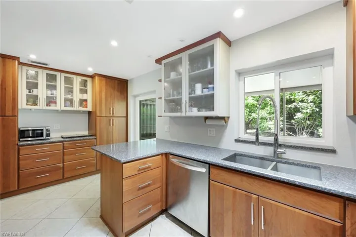 Kitchen features stainless appliances.