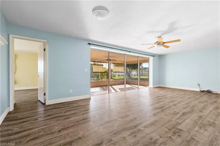 Spare room with a ceiling fan, baseboards, and wood finished floors