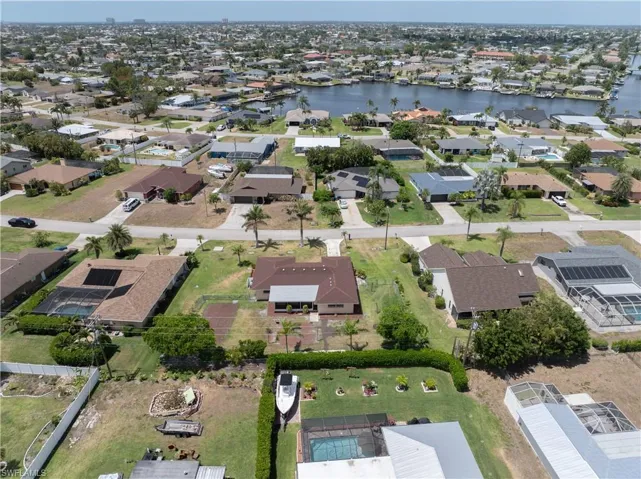 Drone / aerial view with a water view and a residential view