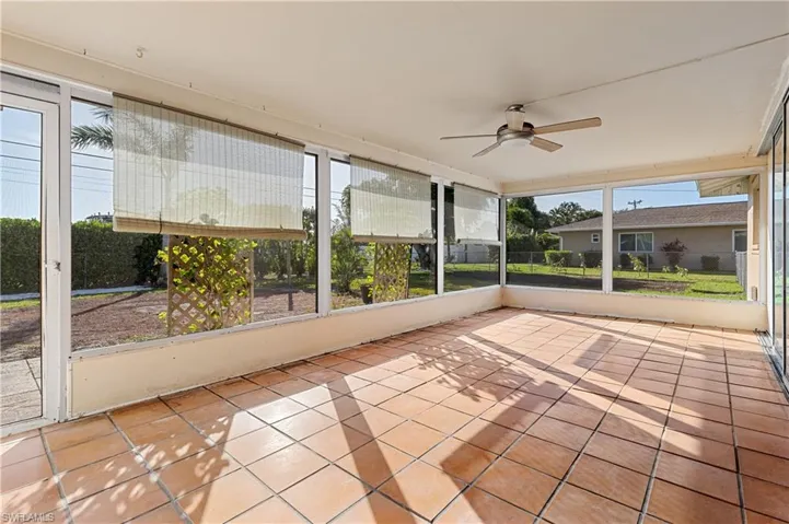 Unfurnished sunroom with ceiling fan