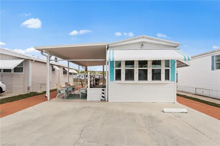 Manufactured / mobile home with a patio and a carport