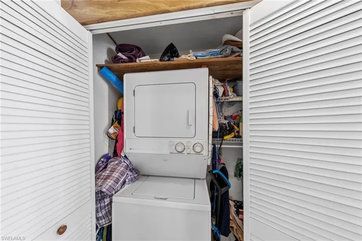 Laundry area with stacked washing machine and dryer