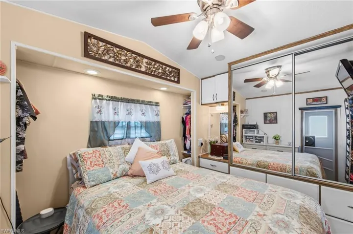 Bedroom featuring a closet, vaulted ceiling, and ceiling fan