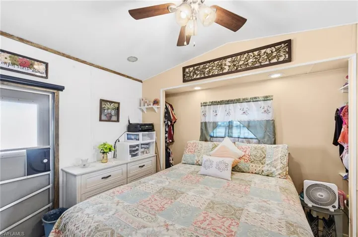Bedroom featuring a ceiling fan, vaulted ceiling, and a closet