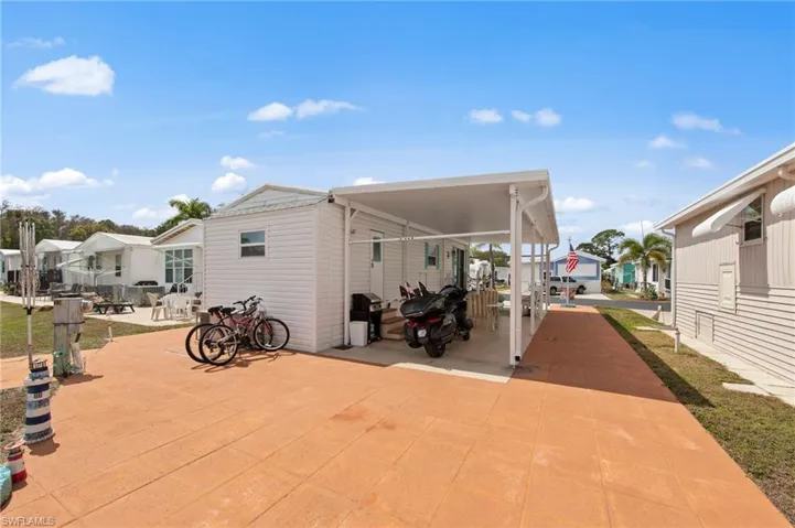 View of patio featuring a grill and a residential view