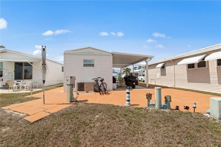 Rear view of property featuring a patio and a lawn