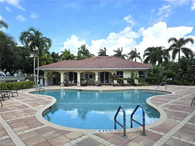 View of swimming pool with club house in the background