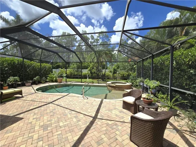 View of pool  a patio area, and an in ground hot tub
