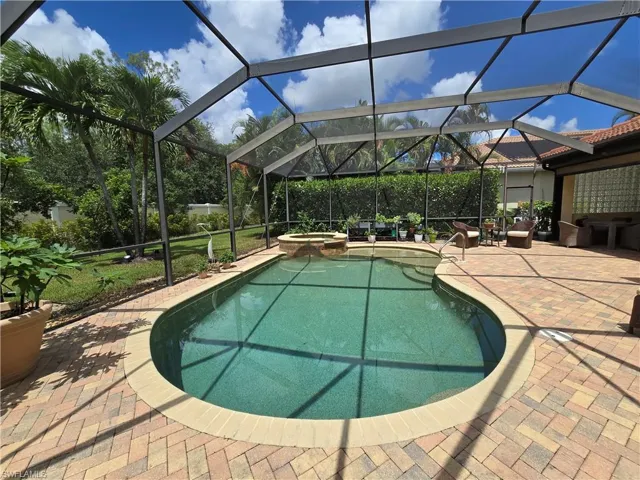 View of pool with an in ground hot tub, and a patio area