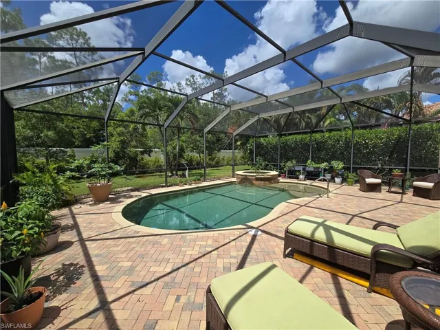 View of pool, patio, and an in ground hot tub