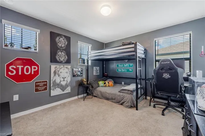 Bedroom with carpet floors and multiple windows