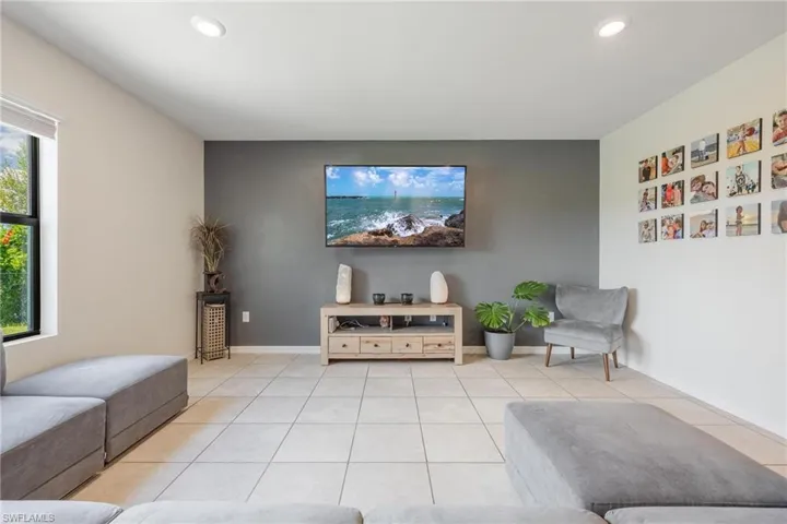 Living room featuring a wealth of natural light and light tile floors