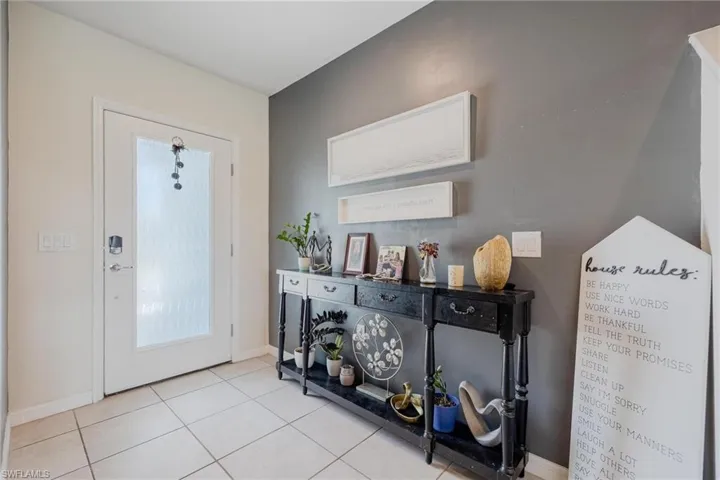 Foyer entrance featuring light tile floors