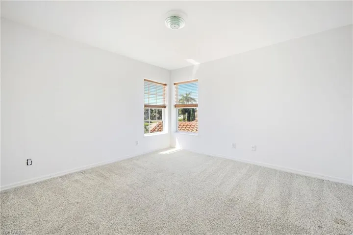 Neutral-toned carpeting and white walls in this interior space