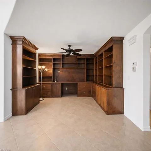 Built-in cabinetry and shelving featuring a rich wood finish and crown molding