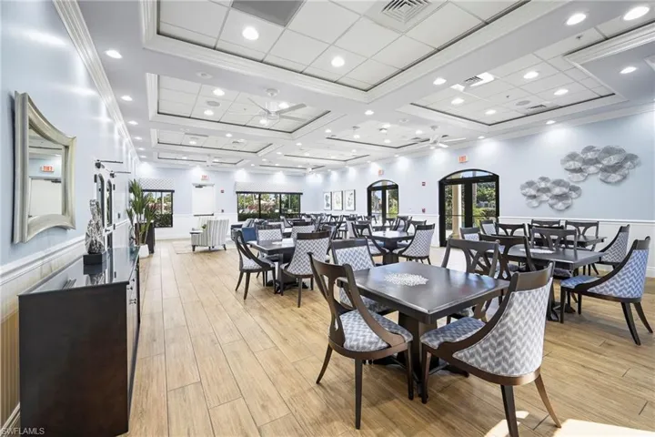 Spacious common area featuring wood-finish flooring, recessed lighting, and tray ceilings
