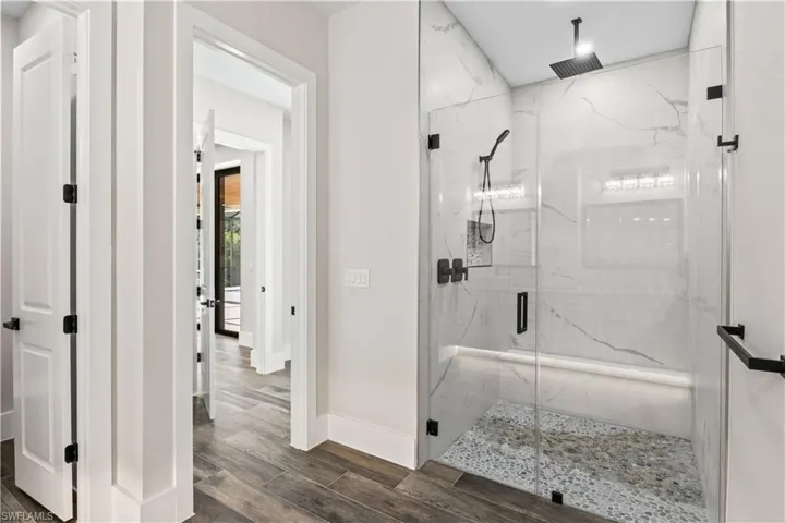 Large walk in shower, multi head as well as rainfall showers as well as a bench and floor to ceiling tile!