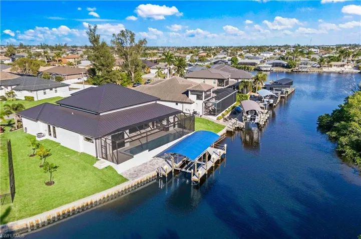 Not only does the home have character but so does the yard - lush landscaping and plenty of room on the side to play.  12,000 pound boatlift with paved secondary deck is a great place to extend the outdoor living space!
