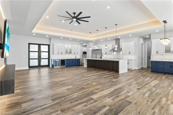 Double front door entry into this magnificent home!  A perfect blend of living space with the open concept and soaring ceilings!  Ceramic plank style flooring throughout with beautiful cabinetry and upscale designer touches.