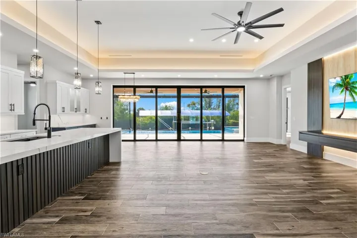 The oversized great room flows beautifully to the outdoors through disappearing sliders, perfect for relaxed living and gatherings.