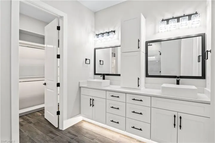 Double floating vanities, each with their own mirror, sink and plenty of storage space.  Under cabinet lighting and walk in closet lighting adds an additional layer of ambience!
