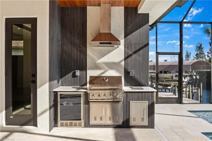 Outdoor kitchen with fridge and vented to the outside!