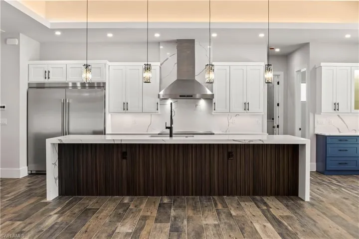 Large kitchen island with 2 inch waterfall cambria quartz and plentiful counter space and storage!