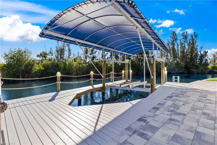 12,000 pound lift with canopy, trex deck and extensive pavered lower patio - add a firepit, outdoor living set and enjoy the view!