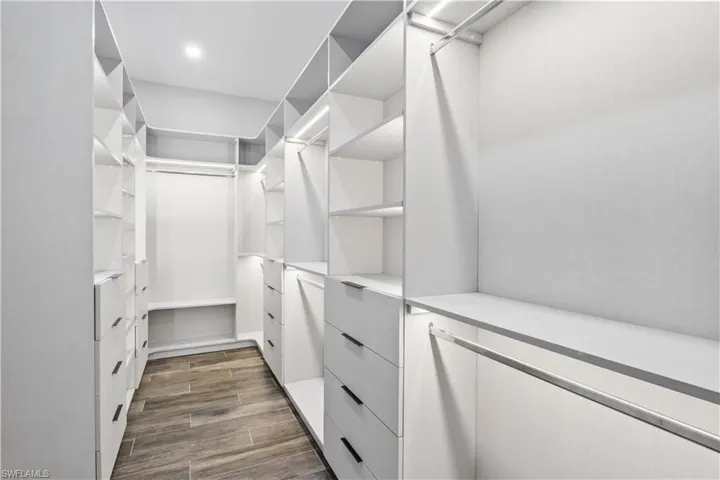 A DREAM closet with a very thoughtful and functional design - beautiful LED backlighting adds ambience and there is so much room for clothes, shoes, purses etc!