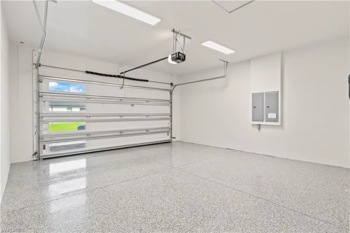 One of two identical two-car garages, providing a total of four-car parking. Epoxy floors have been professionally installed, giving a sleek and durable finish. Each garage features 8-foot tall steel overhead doors, complete with openers and keyless entry for convenience and security.