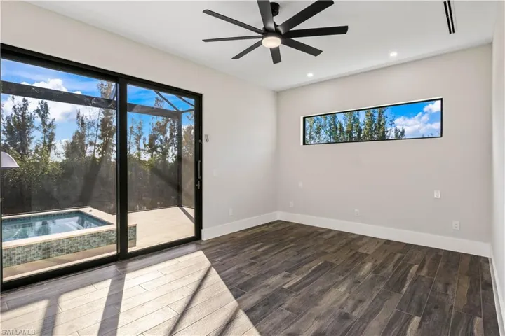 Primary bedroom suite with transom window for natural light, sliders to the outside pool area and reading lights, each with their own switch!