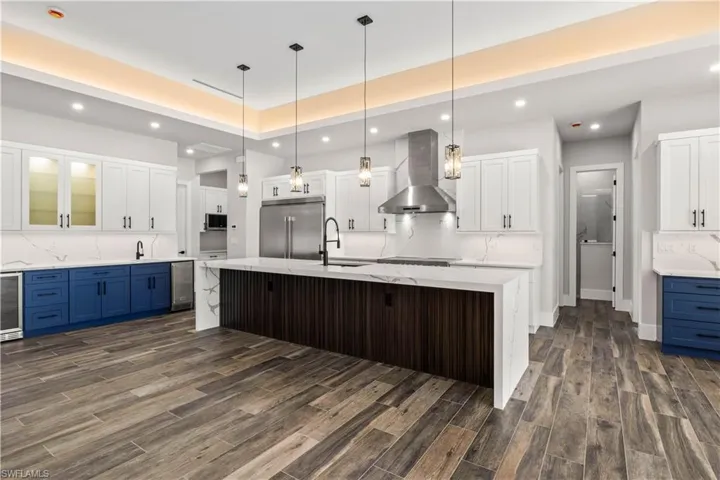 A true chef's kitchen with large island, 42 inch cabinets with pullouts and soft close, undermount large sink, a 66 inch fridge /freezer and a 48 inch macdaddy oven!  There is also a butler's pantry and a wetbar buffet with beverage fridge, wine fridge and icemaker!