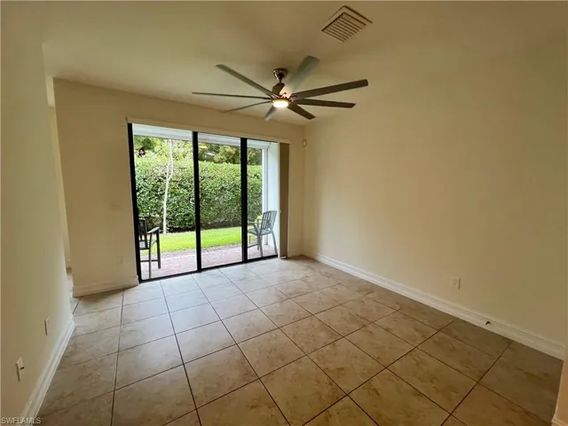 Tiled empty room with ceiling fan
