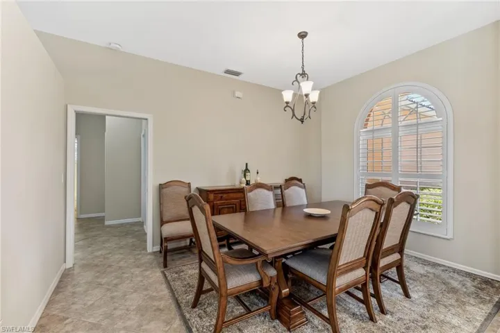 Dining area with a notable chandelier, baseboards, and visible vents