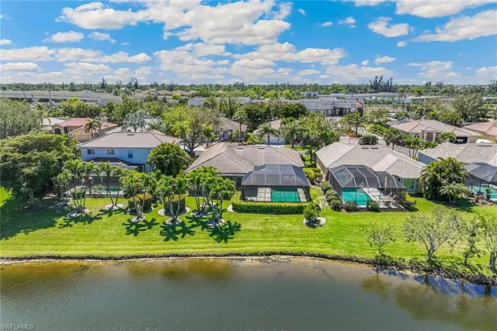 Birds eye view of property with a residential view and a water view