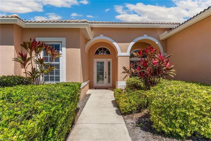 Entrance to property featuring stucco siding and a tiled roof